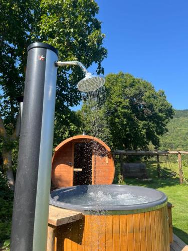 a water fountain in a barrel with at La rosa sul lago in Osiglia