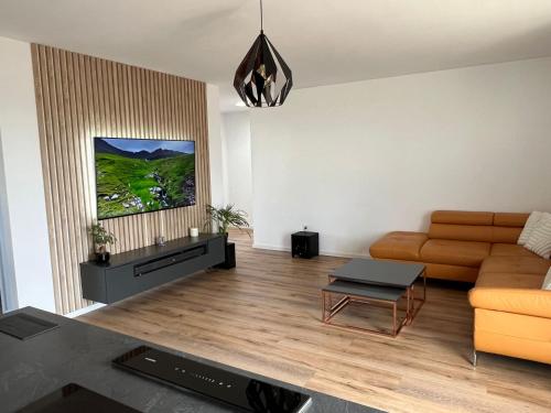 a living room with a couch and a table at Moderny luxusny domcek s vyhladom na zamok in Prievidza