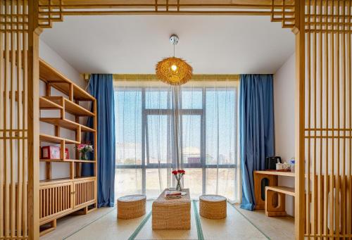 a room with a large window with blue curtains at Zhangjiajie DreamWay Hotel - Free pick up service in Zhangjiajie