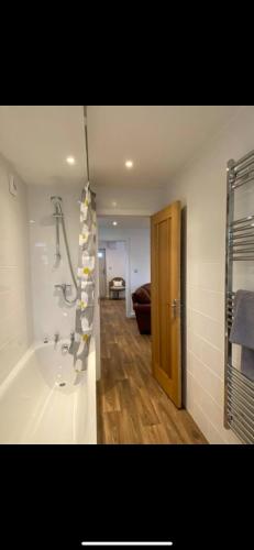 a bathroom with a bath tub and a shower at Seashells in Padstow