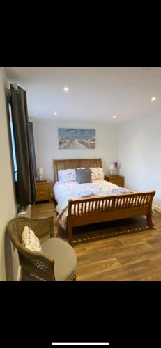 a bedroom with a bed and a table and a chair at Seashells in Padstow