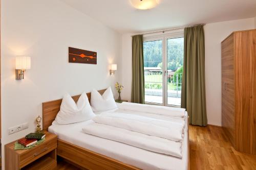 Säng eller sängar i ett rum på Apart Mountain Lodge Mayrhofen