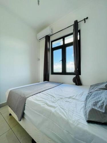 a bedroom with a large bed with a window at Sea View 2-Bedroom Apt, 10mins Walk to Beach - GBHC7 in The Vale