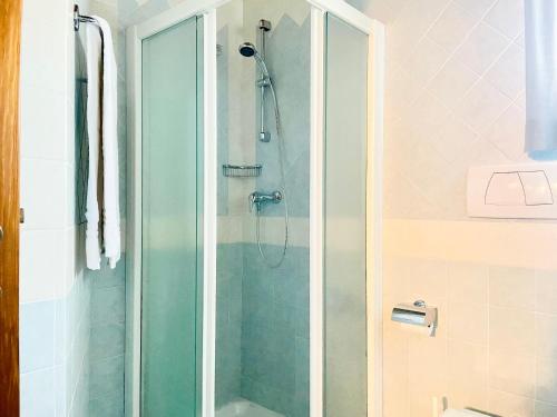 a shower with a glass door in a bathroom at Agriturismo P rato Fiorito in Santi Angeli