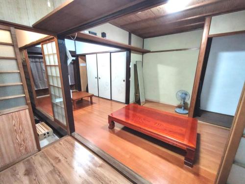 a room with a wooden table in a house at Old style japanese house Minpaku Yanoya in Otsu