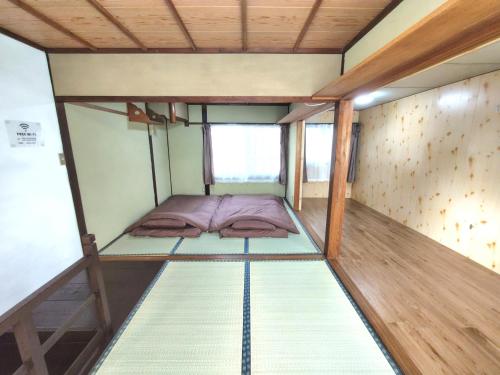 a small room with two bunk beds in it at Old style japanese house Minpaku Yanoya in Otsu