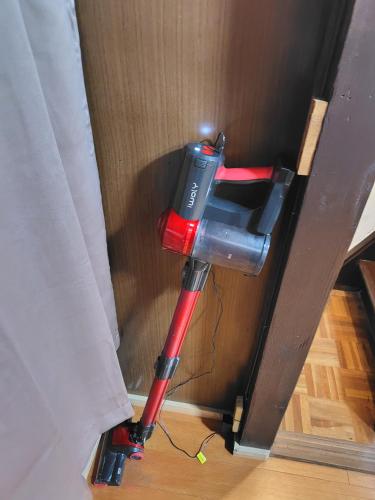 a red object is in the corner of a room at Old style japanese house Minpaku Yanoya in Otsu