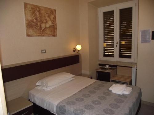 Postel nebo postele na pokoji v ubytování Hotel Elide