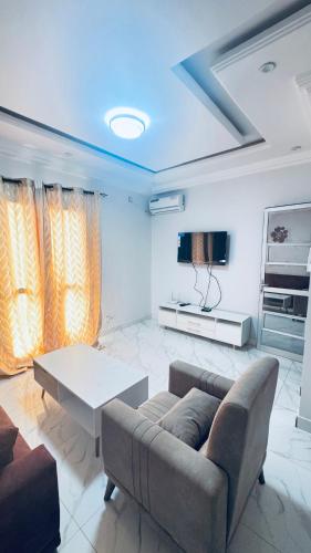 a living room with a couch and a table at SN Virage Almadie 2 in Dakar