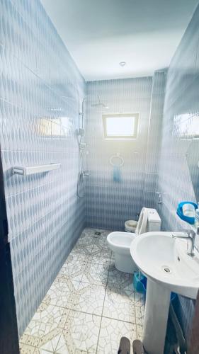 a bathroom with a toilet and a sink at SN Virage Almadie 2 in Dakar