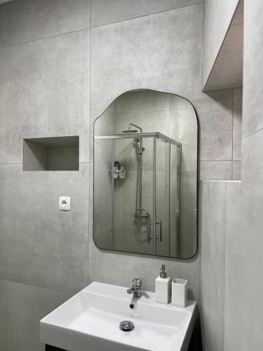 a bathroom with a sink and a mirror at Apartment Korčula in Korčula