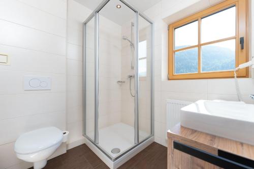 a bathroom with a shower and a toilet and a sink at Berghof Sölden - anno 1588 in Sölden