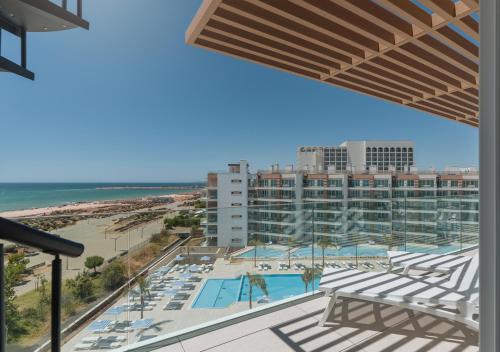 a view of the beach from the balcony of a resort at Dom Pedro Residences in Vilamoura