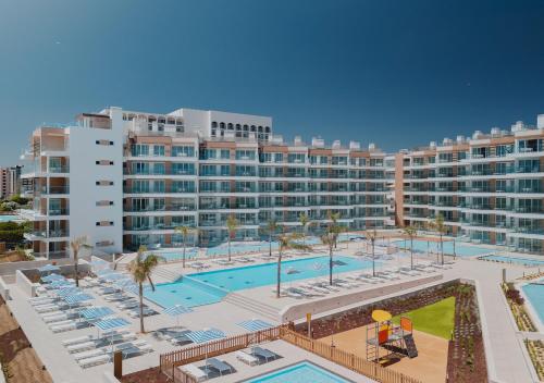 a large apartment complex with a large swimming pool at Dom Pedro Residences in Vilamoura