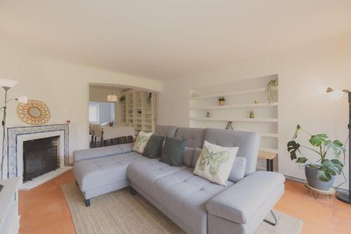 a living room with a couch and a fireplace at The Lisbon Villa with Pool in Lisbon