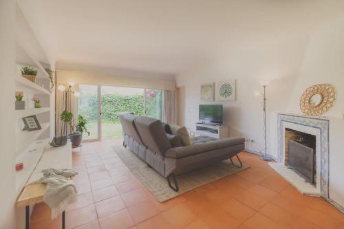 a living room with a couch and a fireplace at The Lisbon Villa with Pool in Lisbon