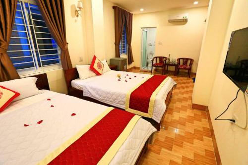 a hotel room with two beds with roses on them at Sun Sea Hotel in Quy Nhon