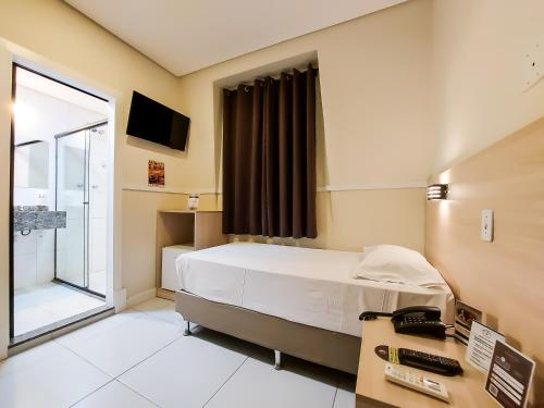 a hospital room with a bed and a window at Hotel Itamarati Centro-República in Sao Paulo