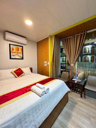 a bedroom with a large bed with towels on it at Phúc Đạt Container in Vung Tau