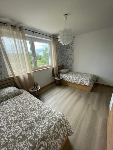 a bedroom with a bed and a window at L'elydiane in Hundling
