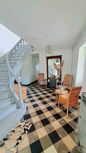 - un salon avec un escalier et un sol en damier dans l'établissement Domaine de Cachaou Logis du Pujeau sauna & spa piscine chauffée, à Salles