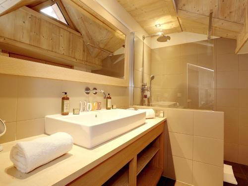 a bathroom with a white sink and a mirror at Chalet moderne 5* à Courchevel La Tania - 12 pers, jacuzzi, sauna, skis aux pieds, cheminée, cinéma - FR-1-575-154 in Courchevel