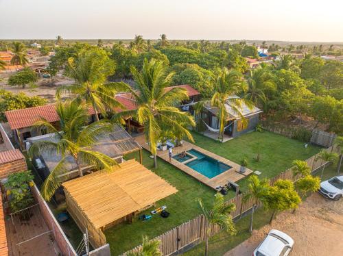 an aerial view of a house with a pool and palm trees at 4 Coqueiros GURIU in Guriú