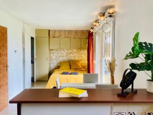 a bedroom with a yellow bed and a desk at Joli studio avec grande terrasse et parking in Vitry-sur-Seine
