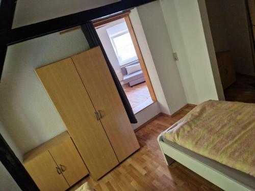 a bedroom with a bed and a closet and a door at Wallaby-1-2-Personen in Brunsbüttel