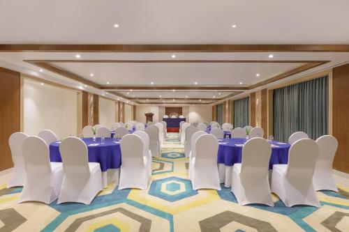 a conference room with blue tables and white chairs at Holiday Inn Resort Kathmandu Budhanilkantha by IHG in Kathmandu