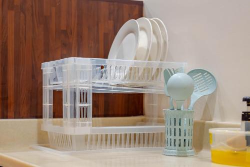 a plastic dish rack with dishes in it on a counter at مسكن نال in Abha
