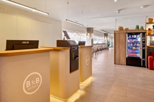 a bar in a restaurant with a drink refrigerator at B&B HOTEL Almería Vicar in Aguadulce