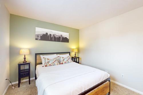 a bedroom with a bed and two night stands at Mountain Stream Condo in Avon
