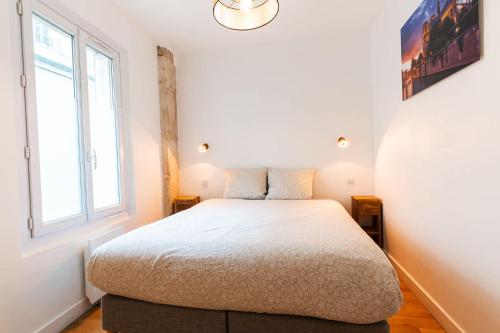 une chambre avec un lit et une fenêtre dans l'établissement Loft 4 BR Montmartre Pigalle AC by LCC Agency, à Paris