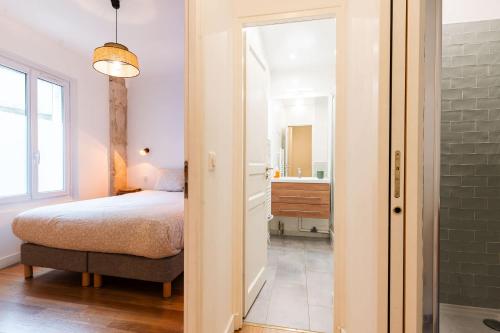 - une chambre avec un lit et une salle de bains dans l'établissement Loft 4 BR Montmartre Pigalle AC by LCC Agency, à Paris