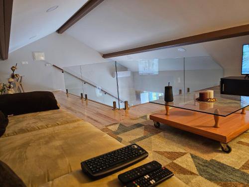 a living room with a couch and a glass table at Cantinho da paz Peacefull Haven in Abrantes