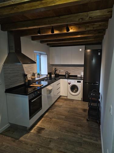 a kitchen with a stove and a dishwasher at Cantinho da paz Peacefull Haven in Abrantes