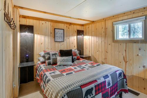 a bedroom with a bed in a wooden wall at Island Park Vacation Rental about 31 Mi to Yellowstone in Island Park
