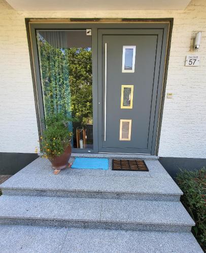 a front door of a house with a potted plant at Haus Traudel in Overath