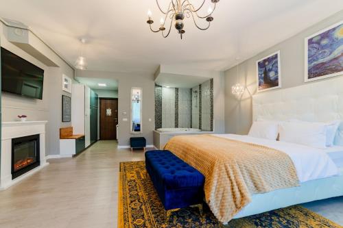 a bedroom with a king sized bed and a chandelier at Romantic Jacuzzi Luxury Apartment in Sinaia