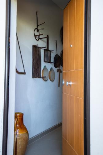 a room with various utensils hanging on a wall at B&B Buongiorno Caprarola in Caprarola