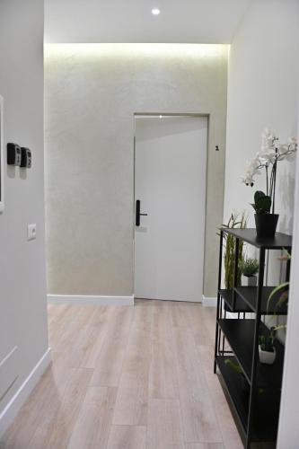 an empty room with a door and a shelf with plants at Galeria's Rooms, Central Tirana, Self Check-In in Tirana
