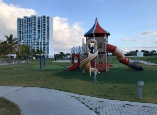 a playground with a slide in a park at Condo by beautiful Lagoon in Río Hato