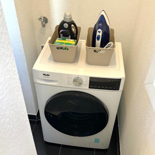 a washing machine with two containers on top of it at Stuttgart Zentrum - Hölderlinplatz - 80qm - EG in Stuttgart