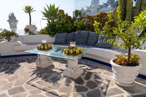 a patio with a table with fruit on it at Relais Bijoux Ischia in Ischia