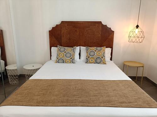 a bedroom with a large white bed with pillows at Anita & Garibaldi in Marsala
