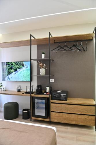a bedroom with a bed and a desk and a wall at Galeria's Rooms, Central Tirana, Self Check-In in Tirana