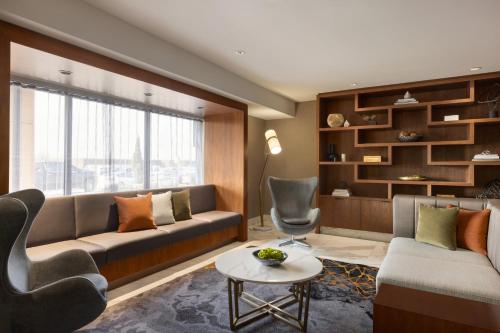 a living room with a couch and a chair at Crowne Plaza Toronto Airport by IHG in Toronto