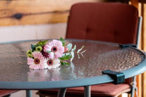 a bouquet of flowers sitting on top of a table at Wellness hiša Jelenov Grič in Mala Nedelja