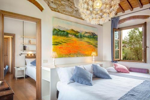 a bedroom with a bed and a painting on the wall at Olimagio Farm Stay with animals and 25m pool, beach at cycling distance in Pietrasanta